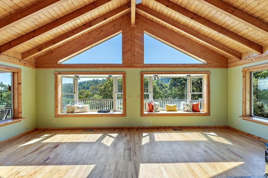 Located just minutes outside of Jacksonville on over 31 wooded & accessible acres w/madrones, oak & fir trees. Nice wide logging rd/hiking trails go to very top of property! This gated 2,394 sqft hm has a huge great rm addition w/oak hardwood flrs & an open beam vaulted tongue &groove wood ceiling w/lots of windows w/natural light & expansive views thru the valley. Master ste, kitchen & living all on main level w/2 addt'l rms downstairs w/sep entrance for possible 2 family set up. Kitch has newer stainless stove, micro & fridge. Tile roof, attached sunroom off dining & lg wrap around deck to enjoy the views & wildlife. This is a truly private & peaceful setting w/a chicken coop, 2 fenced gardens & orchard w/cherry, pie cherry, plum, prune, granny smith, gravenstine apple trees & producing grapevines. Workshop w/power & lots of addt'l covered areas, RV hookup/dump. Attached 2 car garage. Brand new carpet/vinyl flooring, new paint inside & windows washed to take advantage of the views!