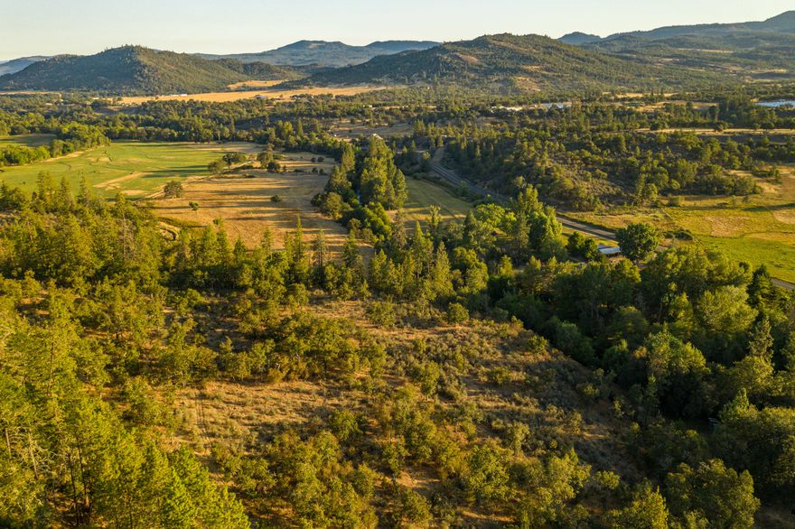 The Lake Creek Ranch offers a unique combination of stunning creek frontage, multiple home-sites, irrigated pastures, dry-land pastures, hunting, trail riding, private shooting range, and more. Little Butte Creek runs through the property for over 2,500 feet. The main home is a charming two-story A-Frame with 3bed/2bath and the 2nd home is a single level ranch style house with 2bed/1.5 bath. There is also a guest suite attached to the ranch office alongside a barn, wood-shop, and equipment storage on the property. A 3rd potential home-site is available as well. There is ample room for horses, large gardens, and additional structures near the existing homes and out-buildings. The property has +/- 32 acres of water rights from Little Butte Creek. The ranch also has opportunities for big game and turkey hunting with over the counter tags and is an easy ten-mile drive to the town of Eagle Point and just a twenty-mile drive from both Medford and the Rogue Valley Intl. Airport.
