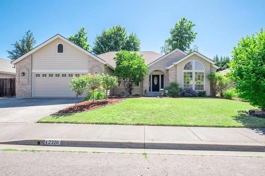 Great neighborhood in East Medford with pride in ownership. Seller has done an amazing job beautifying this home. New carpet, new interior paint, professionally painted kitchen cabinets, hardwood flooring, tile throughout the home with granite in bathrooms and kitchen. Added tile in main bathroom. Vaulted ceilings in master with walk in closet. Wonderful open kitchen with raised eating bar that opens to the family room with fireplace and large built in entertainment center with small wet bar. You will love the formal dining room and living room for entertaining. The backyard features a view of Roxy Ann along with a hot tub, raised garden bed, shed for storage, and an above ground pool for the hot summers. A few other features not to miss in this home are the large laundry room with lots of storage. Natural light throughout and wide hallways.