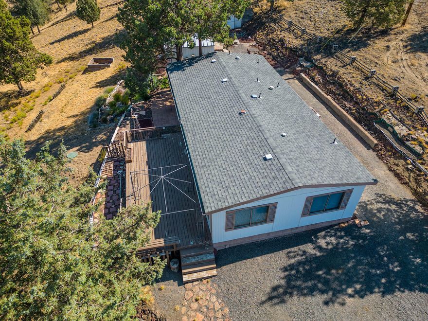 Perched at the end of a cul-de-sac, with wonderful Cascade views, this 2 bedroom, 2 bath home has a lot to offer.  The front deck is spacious and lends itself to relaxing and enjoying those ''top-of-the-mountain'' panoramic views!  In addition, the greenhouse/potting shed will be an asset, when you ''doll-the-place-up'' and fill those flower boxes.  The 16'X20' workshop/studio, has a concrete foundation, power and an air conditioner.  Another building, built at the back of the shop, will make a great storage building, with cabinets in place!  Last, but not least, is the gravel floored, metal building with overhead door, for additional storage.  (Could be moved to use for car storage).  New Trane furnace & heat pump, in 2019, plus new walk-in shower in primary bedroom.  Brand spanking new septic tank!  Once you visit, you won't want to leave!