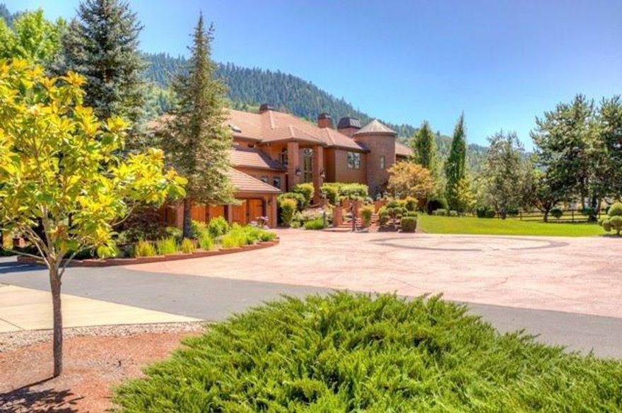 Newly Priced Rogue River Waterfront! 8.07 acre park-like riverfront estate. This gorgeous property overlooks the majestic Rogue River with 900' of river frontage is level and has water rights for the entire property, (fully irrigated with 22 stations). The property features an amazing private million gallon, year round lake supplied by the river and stocked with trout and has a bridge and water fountains. This stately home is the Perfect blend of luxury and quality throughout the 7,046 sq. ft. A dream kitchen with Viking appliances, beautiful family room with mini-kitchen, double-sided fireplace and 8x9 elevator, 2 offices, 4 separate HVAC systems. Swimming pool, spa & expansive decking for entertaining with an outdoor kitchen. The home has a back-up natural gas generator, the home comes completely furnished including riding lawn mower & tractor. Full service A Class RV parking garage with additional room for 3 cars/toys and a 1500sf of living space above that. Buyer to preform & rely