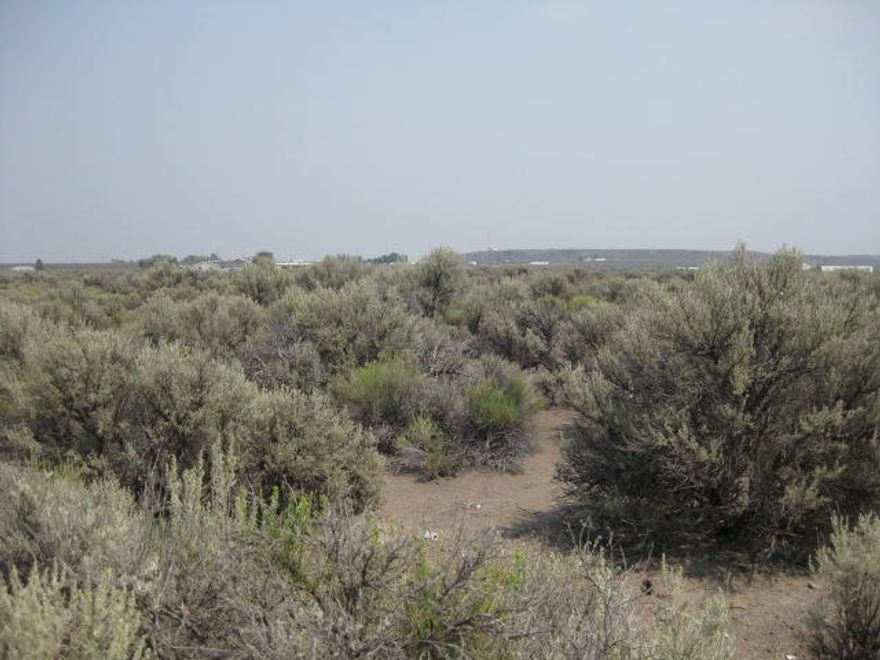 Escape the city and build your dream home or get away on just over 2.25 acres zoned for residential.  Not far out of the town center where you can get groceries, hardware supplies, gas, and have a great lunch at one of the local restaurants too. Play some golf on the local course, picnic at the park, go to the library and more. Area is served by public and private schools.  Enjoy the high desert and all it has to offer. Public Water is available at property line for buyer to have connected. Buyer to do their due diligence.