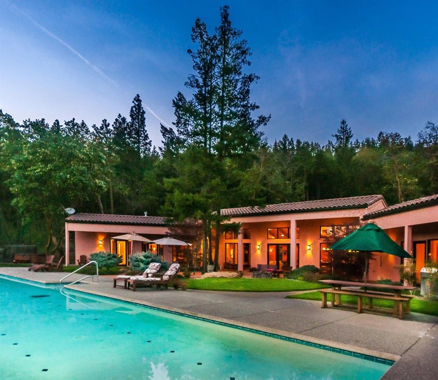 Incredible view estate in the Applegate Valley. Southwestern adobe style custom Pagnini built home featuring expansive south facing valley & mountain views. 75 ft saline lap pool. One level, wheelchair friendly, and power smart with 10 inch walls. Enter this one story home through a weather protected breezeway into an open foyer. Each room features custom cherry cabinetry, large solid teak doors and breathtaking views. Great room has vaulted ceilings, stone fireplace surrounded by built-ins. Kitchen features a large island, granite counters, custom cabinets, large pantry and a wine cellar room. Master suite has a gas fireplace, cabinets, shelves, sitting area, large walk-in closet and 2 person walk-in shower. Home also includes 600 sq. ft. full bath w/kitchen guest house. Heat/Air and pool use Geothermal. 8000 Watts Solar, Wheelchair friendly and only 20 Min's from town. Wood/steel clad windows. Huge garden area w/fruit trees and 22 raised beds. 1750 garage & shop. 22.5 acres w/trails