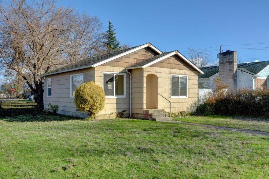 Lots of Potential!  This opportunity is knocking loudly right now!  A perfect first-time home purchase or investment property.  2 bedroom 1 bath, hardwood floors, utility room all ready for your finishing and cosmetic touches.  Refrigerator and range included!  There's also a detached garage with a spacious workshop area.  There's lots of grass, play areas in the front, wrapping around the corner lot to the garage.  About 15 years ago an Access grant allowed for a new HVAC, new roof, new windows, some electrical upgrades and a large tree removed.  Zoned C-4 commercial so you can open your business here, but it's one block from the main downtown Central Point street and the traffic noise.  Buyer to do all your own due diligence with the City of Central Point.  Because of the commercial zoning not all financing is available.  Check with your lender's ability to finance on commercially zoned land.  Seller carry available with minimum of 20% down.