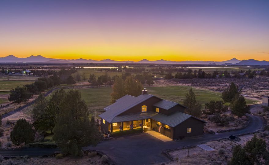 Experience Powell Butte Country Estate living, with 40 Private acres amidst the Central Oregon high desert beauty. Adorned with mature sage and juniper, expansive Cascade Mountain Views, and a Pastoral setting, the well-appointed and pristine home boasts custom features, an excellent floor-plan, all with beautiful finishes: granite counters, hardwood floors, soaring vaults in the living room, central vacuum system, luxurious primary suite with soaking tub.  Enjoy your morning coffee in front of the romantic fireplace with an efficient woodstove insert and stone surround, while watching your morning forecast over the majestic Cascade Mountains. With finished downstairs space, there's space for everyone.  Outside, relax on the spacious deck or the well landscaped yard. Machine shop to store farm equipment, RV's or house livestock. Views are unobstructed in most directions and nature will greet you, with quail, deer, owls, and hawks to name a few.