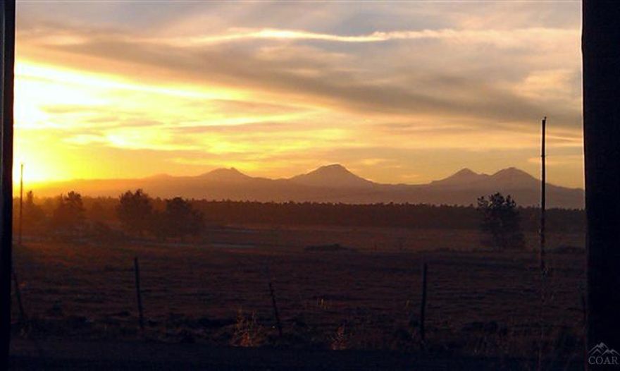 Located in Powell Butte on a dead end road this 160 acres with 103+/-acres of Flood irrigated ground sites picture perfect. With 2 manufactured homes. The main home has over 1900 sq. feet of living space with a daylight basement & a 2 car garage. Second home has 3/2 bath & is classified as a ranch hand home. There is an older barn & a set of corrals for working your livestock. Property is fenced & crossed fenced w/several pastures & hay fields. Open your gate & you can almost ride to Redmond on your horse.