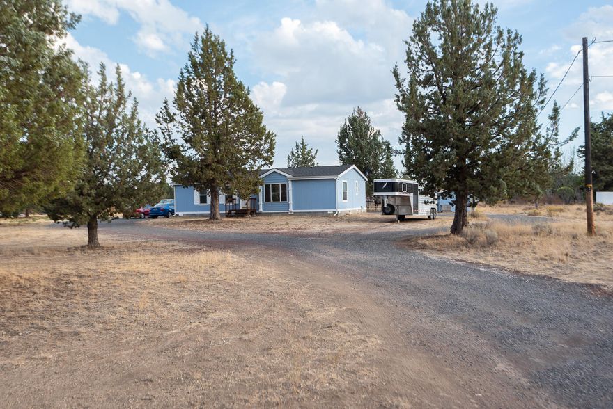 What a cool place! A nice, level 1.8 acres with views of Mt. Jefferson, a well kept home and a 24x30 shop, loafing shed, horse pastures, storage shed and peek-a-boo views of Mt Jefferson! In the home, the owner's suite is separate from the other bedrooms, there is a formal dining room plus an open great room design, large windows and great natural light. The shop has concrete floors and power, the septic is a 1000 gallon concrete tank, and the property is on public water. This is a supremely sweet spot to call home! All appliances plus the Yellow 1950 Minneapolis Moline Tractor are included and YES, the home has tie downs underneath! Crooked River Ranch is an amazing area of Central Oregon with golf, tennis, access to the Deschutes and Crooked Rivers, views, restaurants and lodging.  (the round pen and fence panels are not included in this sale) Sellers willing to credit back $2500 towards buyers' closing costs and/or rate buy down with acceptable offer.