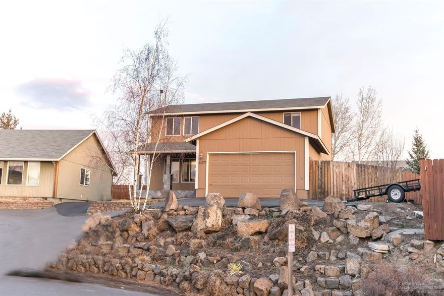 BEST PRICED HOME IN Bend with views of the Cascades and Pilot Butte. Spacious 4 bedroom home (one is super large) all upstairs, with laminate flooring, newer carpet, slab granite kitchen counters, stainless appliances, and newer doors and molding with oil rubbed bronze hardware. The Hearthstone woodstove keeps this house cozy. Large first floor bonus room perfect for media, playroom, or office. The decking outside is spacious leading to a large grassy area all on sprinkler system! Newer exterior paint too