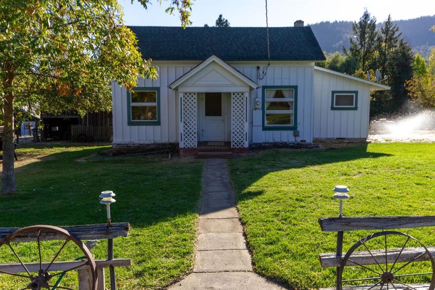 Beautiful setting in the hills of Talent with views of the city lights at night. This property is ideal for a mini ranch or farm with 1.75 usable acres. This an 1890's farmhouse has a large master bedroom and bathroom on the main level. The second bathroom has a turn of the century claw foot tub. The upstairs has the attic' like 2 additional bedrooms, 5 boys were raised in this area! The kitchen opens to the dining room which has beautiful views of the back property. There is a barn/shop, which the barn enclosure could be used for a 4H animal project. This property has flood irrigation from the Beeson & Robinson ditch. There is a RV pad that has its own septic and full hook up on a separate meter than the main home along its own laundry shed. Come out and view this beautiful setting.