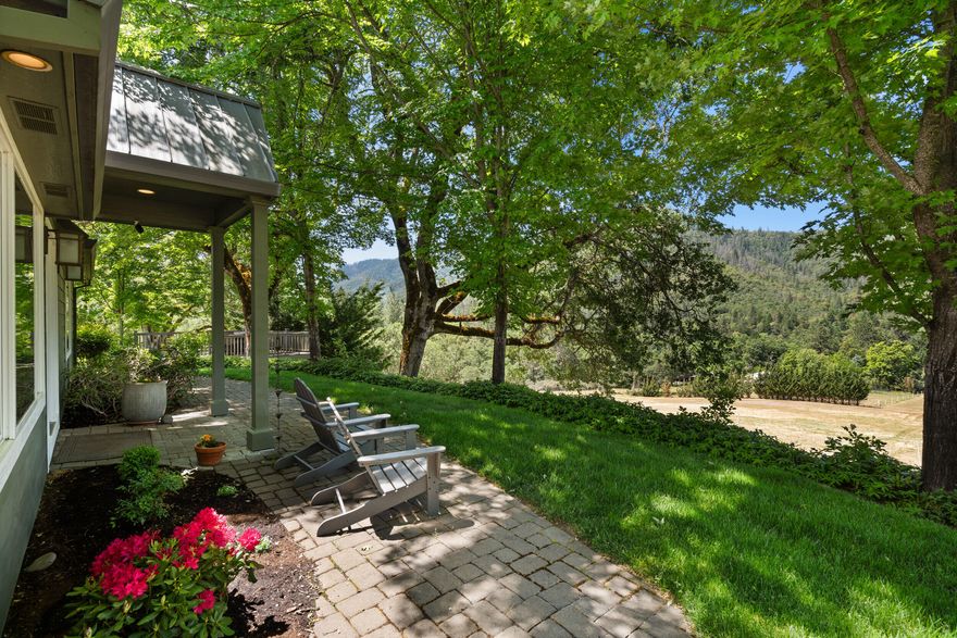 Owner financing available! Stunning 12.13-acre private equestrian estate with panoramic views of the World-Famous Del Rio Vineyards, just 15 minutes to Rogue Valley Int'l Airport and premium amenities. A 2,000 sq ft finished garage with RV storage plus a 760 sq ft apartment with full bath and kitchenette offers flexible living or rental options.
The beautifully updated 2,980 sq ft, 4-bed, 3-bath home features hardwood floors, granite countertops, maple cabinets, a 1,000 sq ft primary suite, updated appliances, and newer windows. Horse facilities include a composite barn by North Coast Barns with two 12x12 matted stalls with run-ins, a tack room, 16x18 foaling stall, and a 12x12 run-in shed. Enjoy mature landscaping, koi pond with waterfall, garden, fruit trees, Trex decking, & a tree-lined paved drive. Dual wells, dual septic, propane generator, RV hookups with dump station & underground 400-amp power make this property fully equipped for luxury living & an active rural lifestyle!