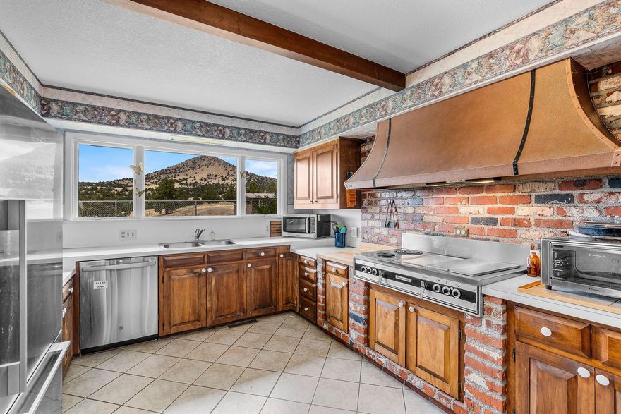 Rare opportunity to own 82+ acres in Mitchell, Oregon! This versatile property includes 35 acres of water rights, is fully fenced and cross fenced, and spans 3 separate tax parcels. You'll find a rustic but functional barn, multiple shops, machine sheds, and hay storage- everything you'll need for livestock, farming, or equipment. The main home sits proudly on a hilltop, offering sweeping panoramic views from every window. Inside, you'll find 3 bedrooms, 2 bathrooms, a large open floorplan, multiple bonus rooms, and 3 heating/cooling sources: woodstove, oil monitor, and full HVAC with A/C. Bonus: a second home on the property with its own well, meter, and septic- ideal for multi-generational living, guest quarters, or rental income. Just minutes from downtown Mitchell and the Painted Hills, this property is perfect for those seeking wide open space, privacy and potential.