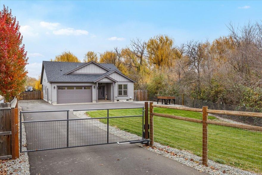 2022 year built 3 bed 2 bath 1772 SQFT custom home on a generous .52AC lot fully fenced,  gated with lots of room for parking, mature landscaping and privacy. There is a adjacent 1.89 AC lot that included in the sale with endless options. Inside the home you will find an open floorplan with the well appointed kitchen as the center of the house complete with custom cabinets, stone countertops, SS appliances and open to the living room with tray ceilings, gas fireplace and laminate flooring throughout. In addition to excellent space for parking there is a nice lawn area and covered patio in the backyard. If you feel like exploring, hop the fence and enjoy your 1.89 acres of wooded property full of life right in town!