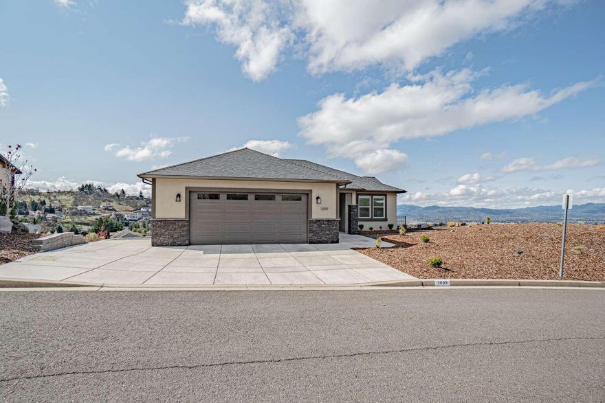 Custom home built in 2023 in East Medford gated community. Situated on 0.4 acres utilizing outdoor spaces and giving stunning views of the valley.  There are no stairs to enter the main level living.  The main level features wider ADA accessible doorways, primary bedroom with ensuite bathroom, kitchen, dining area, living room, guest bedroom, full bath, laundry room and access to the garage.  Lower level has 2 bedrooms, full bath, living room and a separate playroom that can be used as a 5th bedroom if needed.  Both floors have large, covered decks and there is also an outdoor patio with propane fire pit and plenty of room for entertaining.  All windows have custom window treatments.  The two car garage is extra wide and deep for lots of storage.