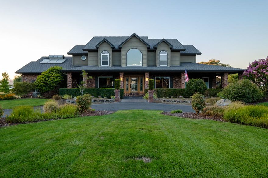 This unique property with unbeatable views, in a park-like setting features an elegant Pacific Northwest style home, remodeled and professionally decorated in 2015, including solid walnut cabinets in a chef designed kitchen, with Wolf, Bosch and SubZero appliances, trash compactor, walk-in pantry, prep sink, pull out cabinets, and copper hood.

The great room features a soaring rock fireplace, built in TV cabinet with surround-sound, automated blinds. The dining room, with double french doors, and built-in bar easily seats 8. With built-in book shelves and a view of the circle driveway the formal living room is a perfect sanctuary. The downstairs master suite features plentiful closets, extra large steam shower and dry sauna.

Upstairs includes 1 ensuite bedroom; 2 bedrooms sharing a Jack and Jill bath, all with walk in closets; an office with generous built in cabinetry.

With a healthy well and irrigation rights, on flat land near town, this property is a rare find.