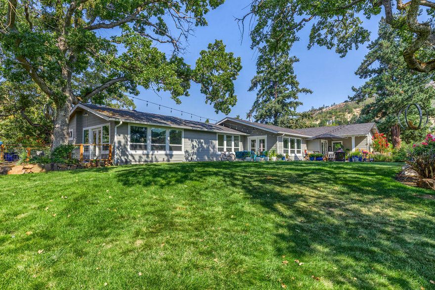 Absolutely stunning property w/City & mountain views! Over 3000 sqft of decking & above ground pool make this property ideal for entertaining! Detached 2 car garage, plus RV garage & addt'l 2 car detached garage; plenty of room for your toys. Home has been completely remodeled inside & out. Some notable features include custom Hastings cabinetry, Hardi siding, irrigation rights, City water & so much more! Spacious living room is light & bright. Amazing kitchen features grand island, stainless appliances & beautiful granite counters. Large dining room is perfect for dinner parties! Full bath off of the kitchen w/a lovely soaking tub. Huge laundry room w/built-ins for extra storage. Primary suite includes a lovely on-suite w/dual vanities, shower w/dual shower heads, walk-in closet w/custom built-ins & French doors that lead to a deck. 2 addt'l bedrooms & guest bath, will spoil your guests. Backyard features 3 levels of decks w/multiple seating areas. This is truly a special place!