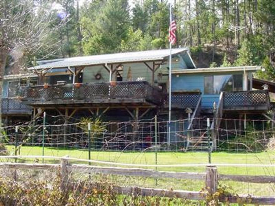 Creekfront. Quiet & Serene Country Living on this 20+ acre property zoned WR. This home offers 360-degree views of mountains, trees & privacy. No Timber Cruise on file, but LOTS of marketable timber here. Home has vaulted and beamed tongue & groove ceiling. Entire lower level is a fully-contained second living area with separate exterior garden level entry. All appliances for both living areas stay with home. Along with countless extras - 35 Horse Tractor, Honda 4-wheeler, wood splitter, compressor, welder, chipper, rototiller & various other handy items to have on a country estate. 960-Sq. ft. shop w/220 & 12' roll-up door. Plus, covered RV/boat storage & tool room. Lots of open sunny areas for gardening. Great well per owner with newer (2016) Pump, piping & Pressure tank. 2012-Septic was pumped, new cap, drain lines & new baffles were installed. Three separate Tax Lots. Need an additional dwelling or Family Compound?