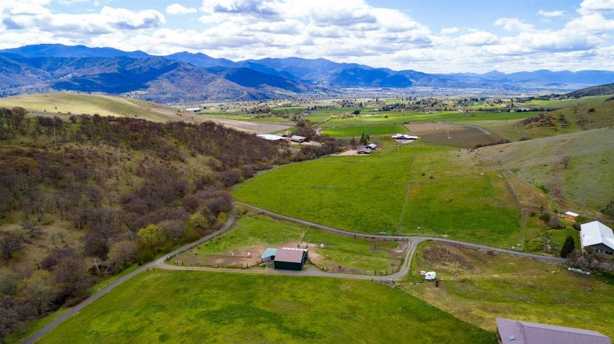 Exceptional opportunity to own south facing EFU land with 12.5 acres of irrigation rights and only a 12 minute drive from downtown Ashland. Private paved and gated access road leads through lovely vineyards and pasture land to this amazing and rare property. The homesite has dramatic views of Mt. Ashland and the surrounding peaks. Seasonal creek, picturesque rock formations and new septic is installed. Includes a large usable barn with solar power and metal roof.
