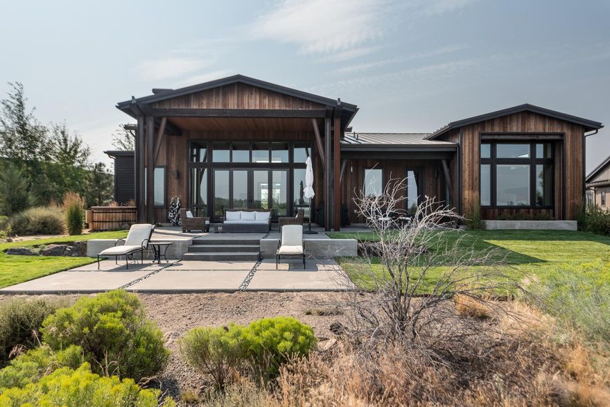 Cool, contemporary designed 3,186 sf single level home in the gated Tartan Druim neighborhood at Tetherow. Overlooking Kidd's Corner, this sleek remodeled home features a vaulted great room with large windows to soak in the natural light, reclaimed beams from a 120 year old tobacco drying barn in Kentucky, 3 en-suite bedrooms, office, bonus room, extra-large two car garage, and huge mud/laundry room. The stylish kitchen includes dolomite counters, stained oak cabinets, Jenn Air appliances and dynamite CB2 light fixtures. The peaceful outdoor space is fantastic with a covered entertaining area, built in firepit, Northern Lights Cedar tub and tiered lounge areas to soak in the sun, enjoy nature and the views. This home is situated just across the street from the community park which features 3 acres of grass, bocce, gas firepit, grill, kitchen and restrooms. Great location close to schools, shopping, and tons of outdoor recreation including direct access to Phil's Trail.