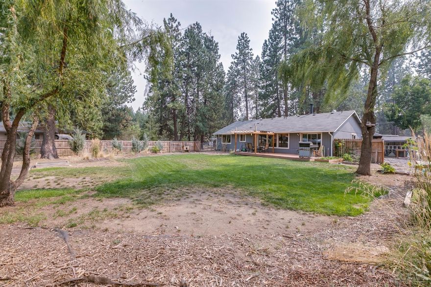 Room to roam! Almost an acre for toys, RV, green grass to play, raised vegetable garden, even a hot-wired horse fenced area with stall. Lovely single level, turn-key home in the peaceful and private, forest like setting of Deschutes RiverWoods. Vaulted living & dining area with large windows for natural light. New Exterior paint, new roof & freshly stained deck with pergola. Extra deep garage with shop area, covered wood storage, carport, extra storage shed and chicken coop. Ready for you to make your own!