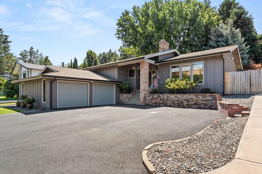 Custom East Medford gem with a complete year round backyard oasis! Enjoy privacy among meticulously maintained landscaping, mature trees, Pami rock, and lawn—all from the expansive 11x50 ft covered Trex patio. New fence with steel posts and covered dog run. ADA wheelchair access through the back patio. Open-concept layout with expanded dining and living areas, newer paint and carpet (last 2 years), Gas Furnace, Gas Range, New Gas Fireplace. Kitchen features granite counters, soft-close drawers, pull-outs in the pantry, and custom spice racks in cabinet. Primary suite offers French doors to backyard, his-and-hers closets, updated vanity, and large tile walk-in shower. Indoor laundry with sink. Huge insulated garage with polycuramine floors, mini-split HVAC, LED lighting, reinforced attic storage, and 15x28 walk-in storage with mats and shelving. Ample parking for toys on asphalt driveway. Turn-key and beautifully maintained with views of RoxyAnn!