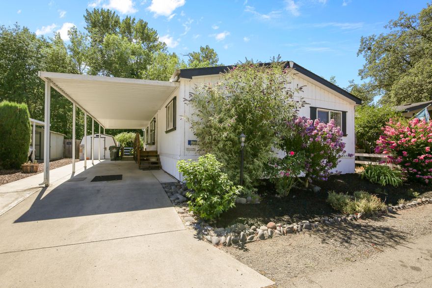 Looking for low-maintenance living in a peaceful 55+ community near the scenic Rogue River? This spacious 3-Bedroom, 2-bath manufactured home in Paradise Park II features an open layout, large den, built-in dining hutch and desk, two storage sheds, covered deck, raised garden bed, new floors, updated paint, and covered parking with both ramp and stair access. A comfortable home with thoughtful extras- don't miss it!