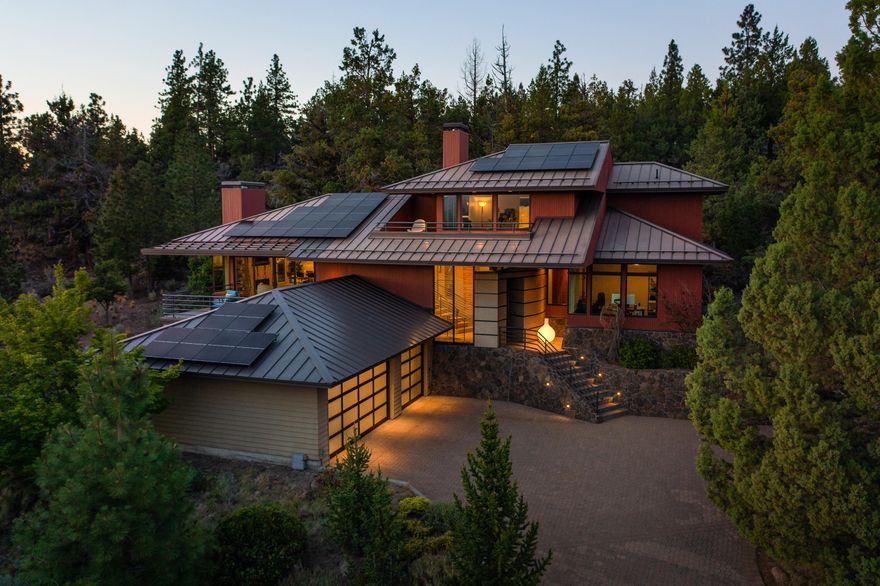 Artfully designed gem high on Awbrey Butte celebrates the Bend lifestyle with panoramic views of the Cascade Mountains. Perfectly private setting nestled into the hillside amongst the boulders of an ancient lava flow offering the best of indoor-outdoor living. Gracious entry welcomes you to an exceptional home styled with sumptuous selections of exotic woods and stone finishes throughout. Open Great Room concept, wholly private Main Suite, large Guest Suites and Den or 4th bedroom. Heated paver driveway and too many tasteful updates to mention.