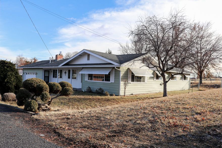 Close to town with a country feel! Loved and meticulously cared for by only two owners, this comfortable home is nestled in the well established neighborhood of West Hills. The property backs up to pasture and has no homes behind it! Mature trees and shrubs adorn this lot, creating a serene and inviting space to enjoy the outdoors. Welcome to this nearly 1900 square feet, 3 bedroom, 2 bathroom home featuring two living spaces (living room and den) which provide an abundance of usable space! The walkthrough galley kitchen has plenty of storage and an eat in bar that opens up to the dining  room.  Make yourself at home and  curl up next to the living room's natural gas fire place or escape to the massive master bedroom (with space for an at home office!). Yes, this home is move-in ready! Yes, there is an attached double garage! Yes, it is the one you have been waiting for! Call for your personal your today!
