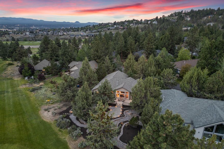 The one you've been waiting for! This single level River's Edge golf frontage home sits on a premier lot, offering a peaceful setting, ample privacy and 3rd fairway views. The vaulted greatroom with hardwood floors, beautiful built in cabinetry and a stone fireplace lend charm to this impeccably maintained property. A wonderfully updated kitchen featuring black-stainless appliances and granite countertops, opens to the dining & living areas; a wall of windows fills the home with light and looks out to the greenery beyond. Step onto the spacious deck and paver patio to entertain, or stargaze from the hot tub. The primary w/ ensuite bath boasts deck access, a walk-in closet, jetted tub and separate shower. Two guest rooms + an office, guest bathroom, laundry room with utility sink, and 3-car garage with 11'+ ceilings & a large storage cabinet - this home has it all. Start living your dream today!