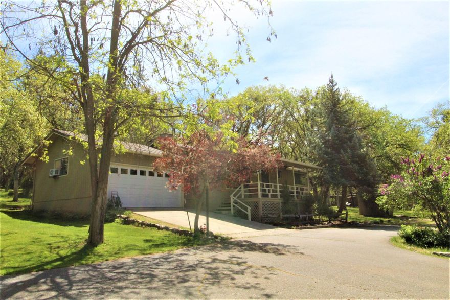 Affordable home in the Sunny Applegate Valley! Well cared for home on almost 3 usable acres located right across from Valley View Vineyard and close to the Applegate River. This 2 bd, 2 bth home has a finished garage also used as extra living space. The cozy living room has a fire view woodstove.  
Newer kitchen appliances, with granite counters and custom cabinets. Both bathrooms have been tastefully remodeled with tile, granite and new cabinets. New extra padded carpet in living area. Heat pump installed in March 2021.  Covered front porch with views to the West. Covered back patio and yard has a very private feel w/ water feature and inground sprinkler system. Paved driveway up to house. Established fruit trees out front with two fenced in garden areas. Detached one car garage has extra storage bays. High speed internet for working remote! Good producing well. Enjoy your outdoor lifestyle and still only minutes to Historic Jacksonville for a night out.