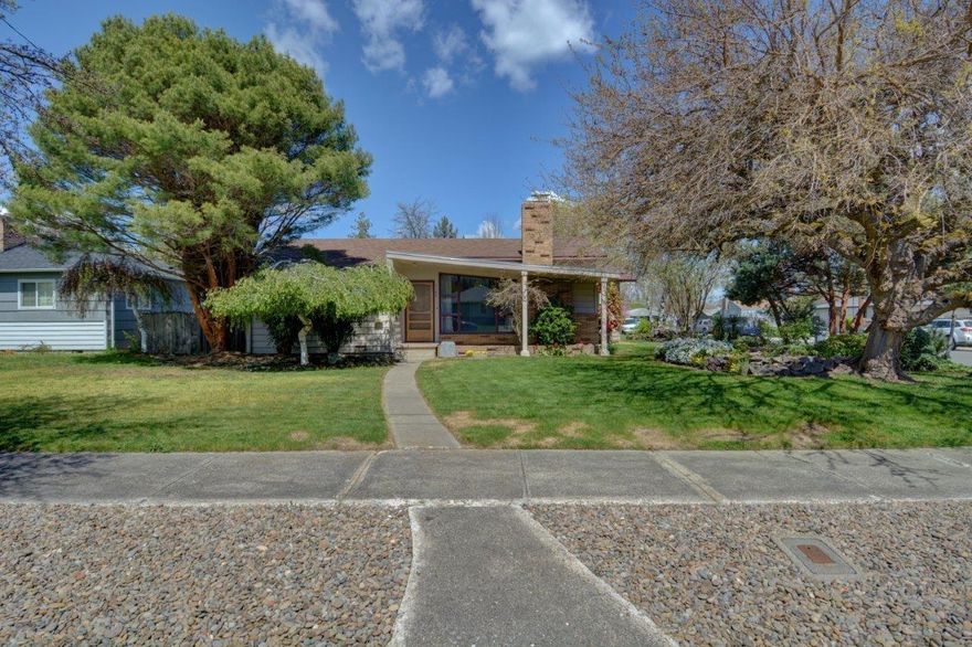 Mid-Century Modern home located in a quiet West Medford neighborhood. Single level with new paint, a mix of newly re-finished oak and new Luxury VP flooring throughout entire home. Brand new granite in the kitchen adds a level of sophistication to the already charming home complete with fireplace. Beautiful landscaping and trees in the front yard provide both curb appeal and privacy. Check out the landmark Mulberry tree! Home has a welcoming backyard with a great patio. Spacious over-sized garage and RV parking, this corner lot will be gone soon! Move in ready and priced to sell!
