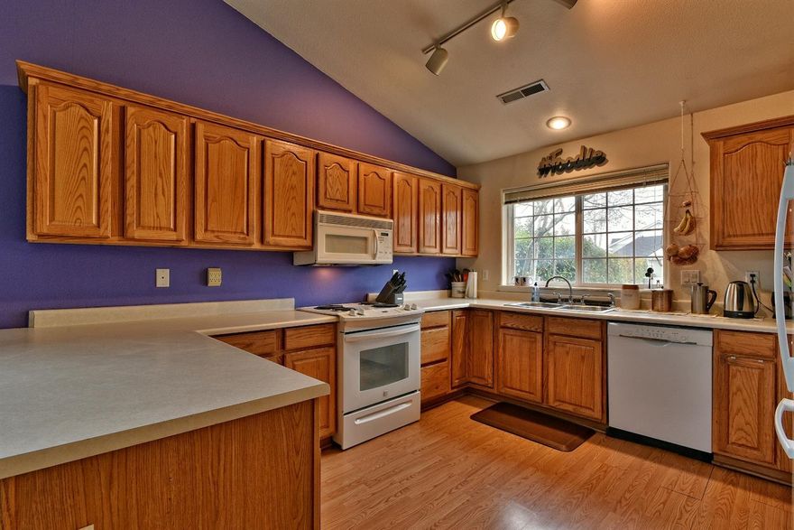 Modern and spacious East Ridge Village townhome. This is one of the larger homes in this development offering 3 bedrooms, 2 full baths, a gas fireplace, and an attached garage. This is also one of the few homes that has the assigned parking space directly in front of the home. The master is on the main level as well as the inviting kitchen and main living space. Upstairs there are 2 bedrooms and a bathroom. One of the upstairs bedrooms has two large closets and a lovely view. This unit abuts single family homes to the rear and there is a beautiful flowering cherry tree in the backyard as well as providing shade and offering a serene setting in the back yard for your enjoyment. HOA dues $195 per month and includes, water, sewer, roof, ext building maintenance, landscaping, parking lot, pool, and clubhouse.