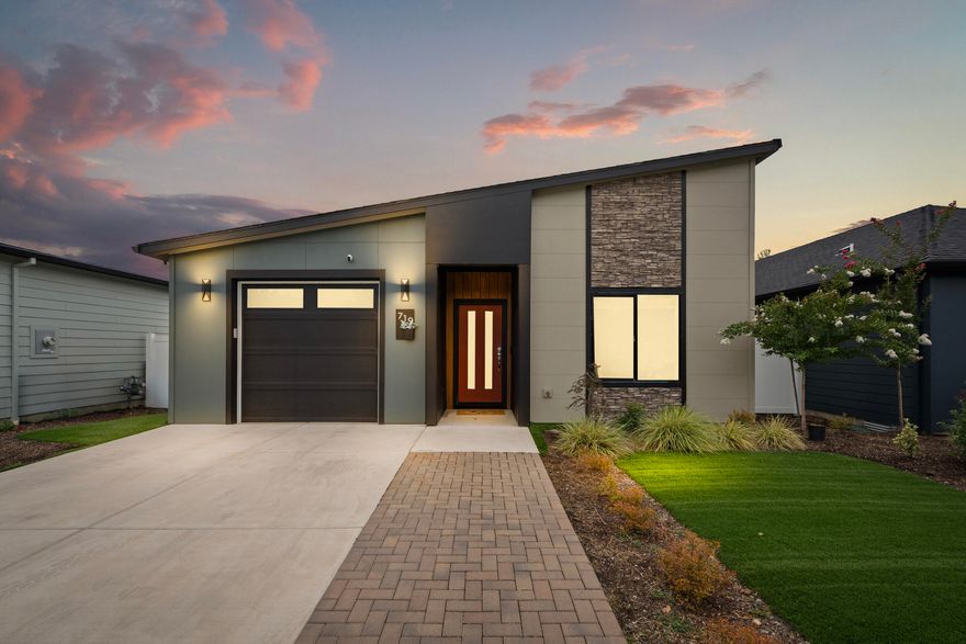 Welcome to 719 Terrazzo Way—where modern comfort meets timeless design in the heart of Medford. Built in 2021 by Rispoli Design & Build, this single-story 3 bed, 2 bath home offers 1,440 sq ft of thoughtfully designed living space. A mid-century modern style with high-end finishes throughout. Enjoy vaulted ceilings, luxury vinyl plank flooring, quartz countertops, and soft-close Diamond cabinetry. The spacious kitchen includes a large island, stainless steel gas appliances, and pantry. The exterior features 100% Hardie non-combustible siding and trim, landscaping, and fencing. Energy-efficient upgrades include a tankless water heater and fully insulated garage. Conveniently located near shopping, dining, and parks—this is low-maintenance, high-quality living at its best!