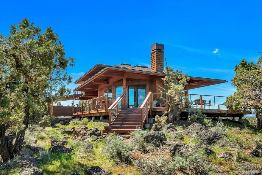 This truly remarkable high end custom home is surrounded by nature with stunning views in all directions from Smith Rock to the Cascade Mountains. A very private setting on 11+ acres above the scenic Deschutes River with over 300 feet of river front provides superb wildlife viewing and fishing right from the property. The contemporary yet warm and inviting main residence is 1569sf while the studio is 652sf w/ a 2 car garage. Quality construction throughout includes radiant heated concrete floors, a wood burning rock fireplace w/ juniper mantle, copper countertops, a slate tile backsplash, solid wood doors, peeled log accents, a hand hammered copper sink in the master bath, mahogany decking and cedar siding. Large windows, vaulted ceilings and skylights bring the outside in creating a light and airy feel. Studio is perfect for guests or creative space w/ bamboo floors, solid wood doors, tile backsplash and wood stove. A hot tub for stargazing completes this one-of-a-kind property.