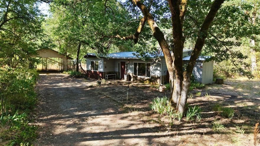 Back on market- No fault to seller. MOTIVATED SELLER. Looking for the perfect blend of farm life, rural charm, and an updated cabin? 

This inviting 2-bedroom, 1-bath home sits on over 12.36 acres of usable land, offering endless potential for homesteading, horses, or simply soaking in the peace and quiet of country living.
The property includes a garden area, carport, shop, horse stalls, and a horse arena—everything you need to create your ideal rural lifestyle. In the spring, the land comes alive with vibrant flowers, mature trees, and visits from local wildlife, making it a true nature lover's retreat.
Recent upgrades include a new roof, new back patio, enclosed wood shed, new gutters and downspouts, a new certified wood-burning stove, and mini splits, bringing both comfort and efficiency to your country home. This gem is just waiting for someone to bring it fully back to life. Don't miss out on this unique opportunity to own your own slice of country paradise!