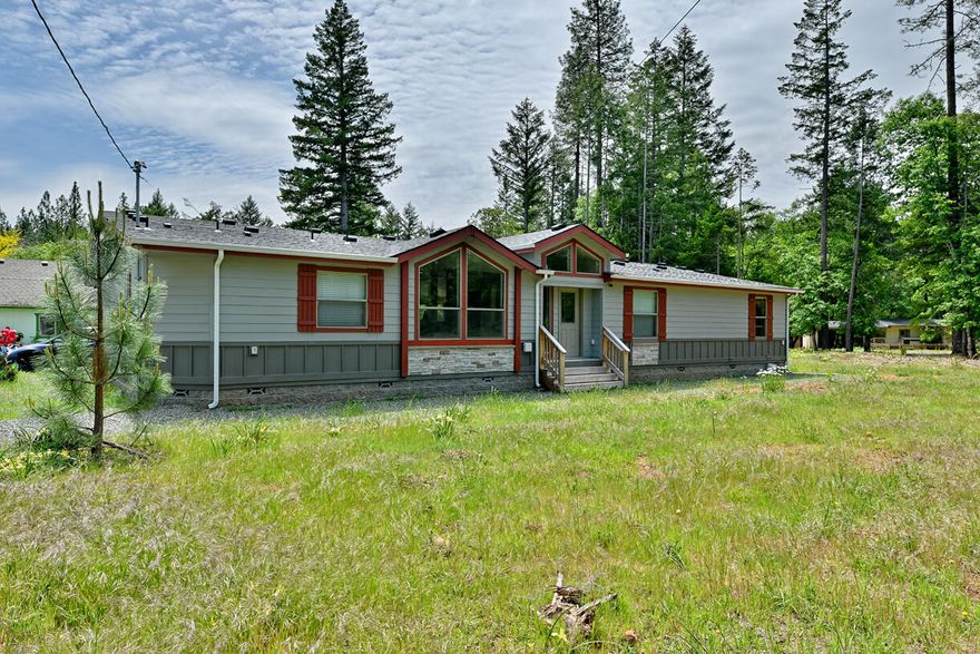 Beautiful 5.01 acres in a desirable neighborhood boasting a new 2023 custom-built triple-wide manufactured home.  Various custom features include the kitchen, living room, and bathroom cabinets, built in storage and an extra large wine cabinet that can also be used for a second pantry.  There is LVP flooring, vaulted ceilings, picture windows and an office space.  The property has a bonus possible quaint ADU 2bd, 1bath, 1 car garage for additional living space. Included on the fully fenced and gated property are 2 20x60 greenhouses, a detached 2 car garage, a steel RV cover and a spacious fenced in garden area.   This property is fully functional with a well, septic and public utilities.  Garden areas, established natural foliage and flowering plants are absolutely stunning! Schedule your showing today!