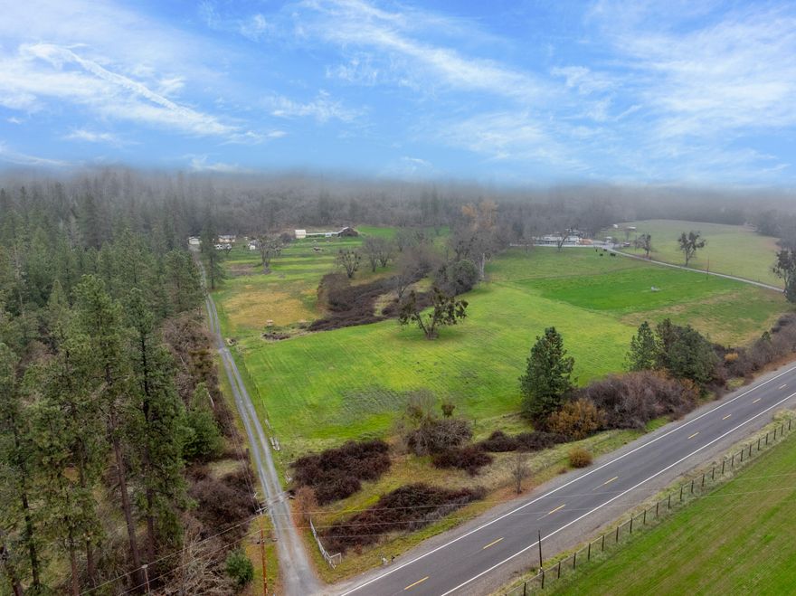 In the desirable Applegate Valley, in the area of numerous well known vineyards sits a Brand New 4bd/2.5ba, 1508sf home with metal roof and Brand New detached 2 car garage on 10.18 EFU acres that backs up to 120+ac of BLM land which is next to another 300+ac of BLM land.  Accessory buildings need to be loved again: Barn, animal pens, storage buildings, workshop area, greenhouse and more!  110gpm (when drilled) from one hour jet test. The entire field (approx 7-8 acres) has inground sprinklers installed with a mix of popup & rainbird-type sprinkler heads controlled by electrical valves so there is no piping to pack around. Needs a controller installed but all the wires to the valves seem to be intact, per seller.  Call for Appointment Today!