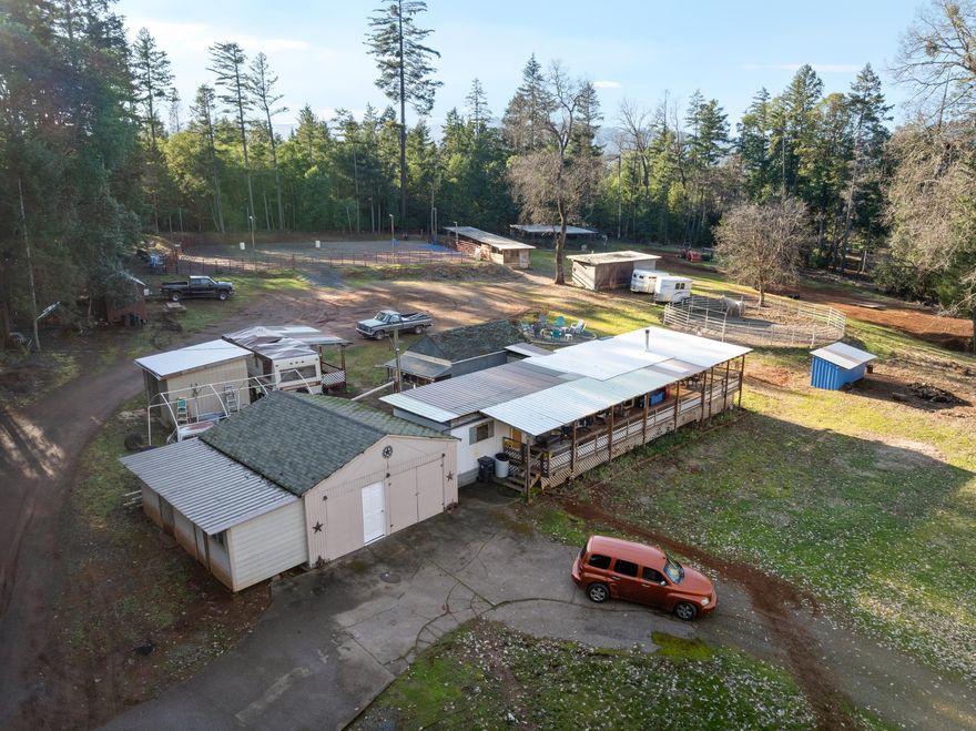 POSSIBLE OWNER CARRY ON THIS AFFORDABLE HORSE SET UP! Welcome to this peaceful, private & beautiful horse property.  Set up for beginners to the very advanced equestrian.  It has something for every level of enjoyment. You can ride, practice or train in the fenced 110 X 110 working arena that was set up to be used all year long.  Also a 50-foot round pen, 6 horse stalls, a hay barn, garage, outbuildings for storage & much more.  You can live in the 1969 mobile that is a 2-bedroom, 1 bath with a stick-built addition used as a 3rd bedroom or build your dream home.  Entertain? You can BBQ or visit with friends & family on the covered deck or sit around the dedicated fire pit.  Enjoy the pond, & every aspect of this ready to go property that has been well manicured around the home & functioning areas to make this peaceful rural setting much safer for the family, pets and horses during any season of the year.  Per sellers well is 20 gpm.  Call today for a tour! WATCH FOR OUR OPEN HOUSES!!