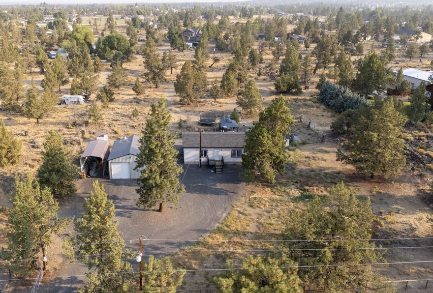 Dead end street offering privacy for this fully fenced property with security gate sitting on just under 2.5 acres outside of Redmond! Fresh exterior paint along with the 24'x30' shop was upgraded with power, concrete flooring, shelves and wood stove. Kitchen is updated, has a pantry and all bedrooms have walk in closets. The primary bedroom and bathroom are generously sized, this is a great floor plan! The doghouse/shed is fully insulated with power. Just five minutes from downtown Redmond, 10 minutes from Tumalo, and 20 minutes from Bend. There is so much more potential, don't miss out!
