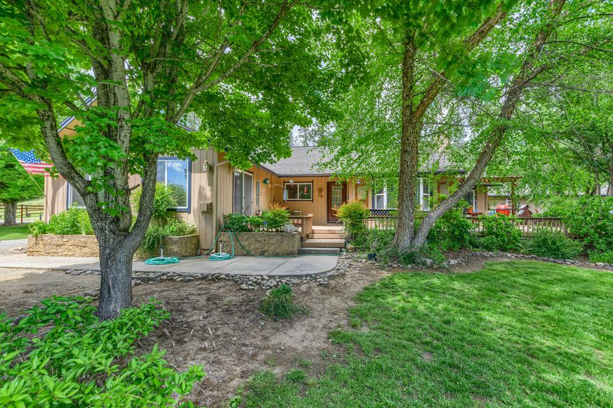 At the end of a long drive is a great 4.49 acre mini ranch gated with wheel line Irrigation. Property all fenced for animals. 1990 sq ft home 3 bedrooms 3 baths. Laminate floors except in 2 bedrooms is carpet.  Kitchen granite tile countertops, large pantry, pullouts in cabinets, tile bathrooms, Large master bedroom,  master bath has jetted tub and separate shower. Large living room with bay window, gas fireplace. Very large insulated attic  space can easily be converted for larger space in home.
Large garage 30x 40 with 220, tack room and covered carport. 2 stall barn/stable with run.
Green house, chicken coop, various garden beds, sprinklers, fruit trees. all in a beautiful setting with gorgeous mountain views!