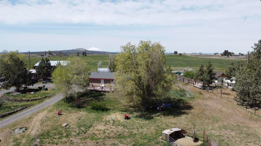 This family is selling their beloved residence they have used as their self-sufficient homestead ranch & farm. Mountain views on one side, valley & Grizzly Mt the other side. All fenced & setup for horses, chickens & farm animals. Deschutes irrigation .7 water-rite, 52'x72' concrete floor, two RV indoor spaces w/overhead doors w/openers, canning facility, hobby work-room, two lofts, 220 power & shop & appliance facilities, on own meter. 14'x32' she-shed w/ elec & insulation. 10'x12' garden/storage shed, heated greenhouse structure & animal sheds. House is remodeled, newer kitchen & awesome countertops, wood stove, laminate floor covering's, window coverings, front deck, newer paint interior & exterior... excellent condition. New roof 2021. Optional year 2000 F-350 super duty 4 wheel diesel quad cab w/goose-neck, backhoe, 16' boat & hydraulic wood spitter can be purchased to stay on property.