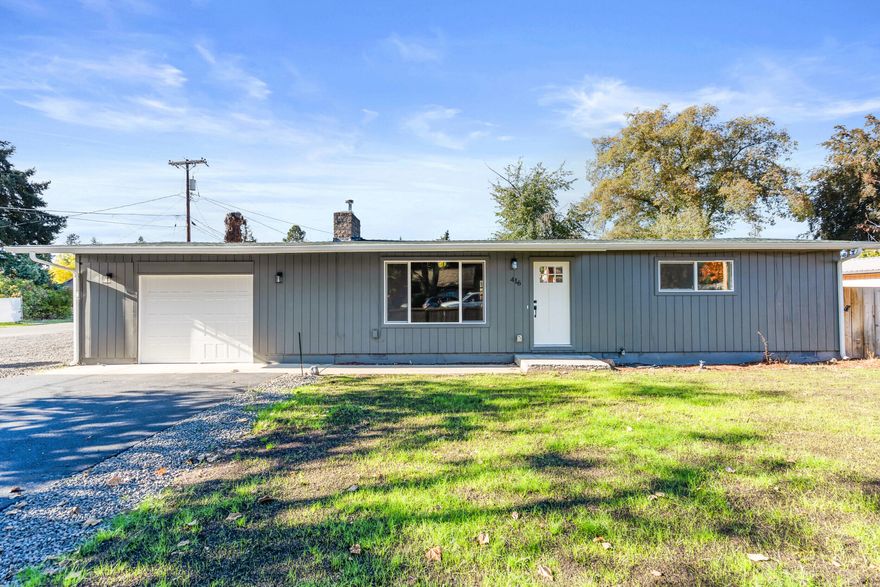 Completely remodeled, updated and move-in ready, this 4-bedroom, 2-bath home offers 1,462 sq. ft. of comfort on a spacious 0.20-acre lot. Step inside to find an inviting living room with large picture window and an elegant electric fireplace. The kitchen shines with natural wood cabinetry, granite countertops, stainless steel appliances, and vinyl plank flooring throughout. The functional floor plan provides comfortable bedrooms, updated bathrooms, and modern finishes from top to bottom. Outside, enjoy the brand new deck overlooking the fully fenced backyard—perfect for entertaining, relaxing, or a perfect place for pets. The freshly paved driveway, large space on the side of the home and attached garage provide plenty of parking, including space for your RV or other toys. Centrally located in the heart of Eagle Point near schools, parks, and shopping, this home blends small town charm with modern living.