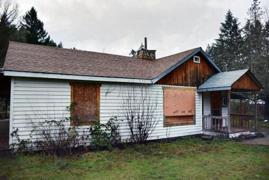 Cottage in the woods on 1.29 level acres with a seasonal creek beside the back boundary. Mountains views and ready for your personal touches to make this a home. 2 bedroom and 2 bathroom house with wood plank walls and wooden floors in the living areas. Separate storage / utility room off the 1 car carport. There is plenty of room to have a vegetable garden and orchard and even build a workshop. There is no water source. Call your agent to make an appointment to view this parcel...