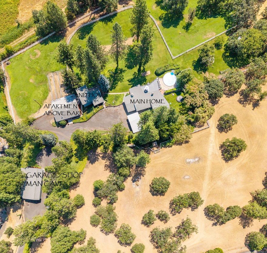 Attention investors! Very rare opportunity; 3 Mid Century Modern homes, Shop w/Studio/Office, Pool, Barn w/ tack room, 3 stalls, Storage rms, fenced & cross fenced all on beautifully maintained 7.97 irrigated acres w/stunning views of the valley. Paved drive. Main home 2648 SQ FT, 4 bdrms, 2 baths w/floor to ceiling windows w/open beams, stone fireplace w/built ins, newer lg deck overlooking the valley and pool perfect for entertaining. 2nd home 1152 SQ FT, 3 bdrms, 2.5 baths, Open beams, tile kitchen, walk in pantry, floor to ceiling brick fireplace, balcony off 2nd floor.  3rd house is above the barn w/1080 SQFT, 2 bdrm, 1 bath, mini kitchen w/ lg living rm.  All 3 homes are in need of updating and being sold in their AS-IS condition and Buyer to conduct their Due Diligence for their use.  Very unique property with forever views close to Jacksonville, Medford, Wineries and the Airport.