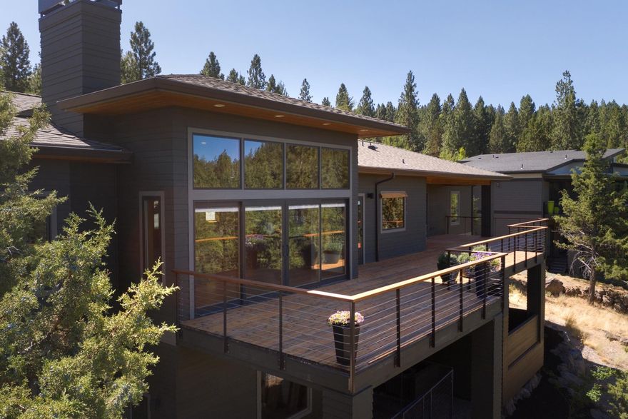 This stunning contemporary home on Awbrey Butte was meticulously built by the owner and shows pride of ownership with every detail.  The large windows flood the home with natural light while maintaining privacy.  Beautiful cascade mountain views and can be seen from every room on the main level.  The chef of the family will appreciate the 5 burner Wolf range, large Sub Zero refrigerator, ample counter space & butler's pantry. The 1000 SF of deck offers an outdoor kitchen and glass garage door from the garage for additional entertaining space if needed.  In addition to the over sized 2 car garage there is 1,121 SF of shop space on the lower level with a separate 10 foot garage door which is really rare for Bend's Westside.  Some upgrades you don't see is that it was all built with plywood (no osb), 50 year roof, copper plumbing, wired for sound, and radiant heat in the bathrooms. This is truly a magnificent home!