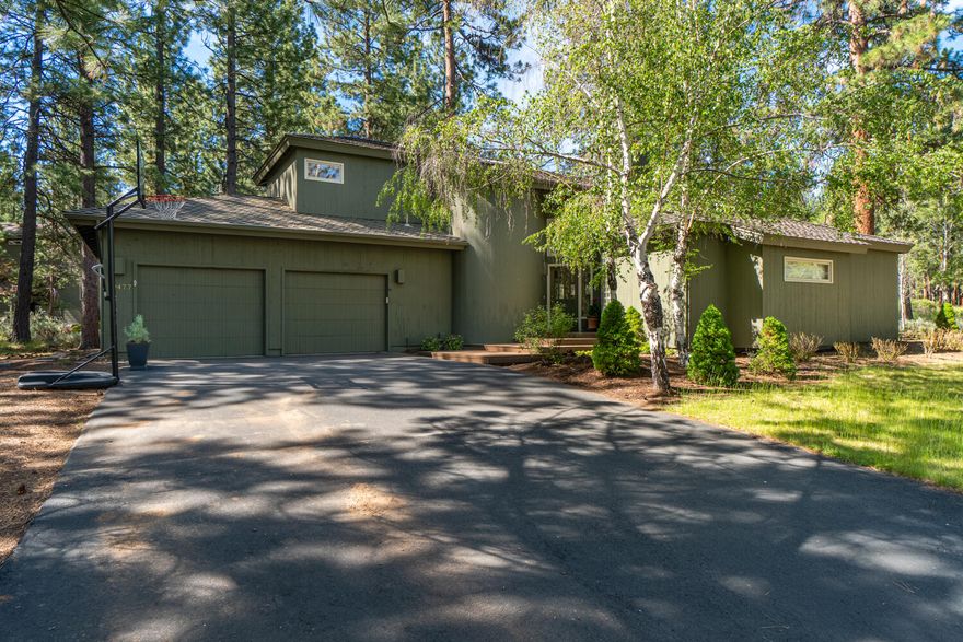 This beautiful NW contemporary home is located in the highly coveted Sunrise Village neighborhood on Bend's west side. Situated on a .39 acre corner lot with beautiful trees and natural vegetation, you'll love the unique architectural features. A welcoming entry brings you into a great room with soaring vaulted, wood ceilings, warm and open updated kitchen with new appliances, solid granite counter tops throughout, a dining area and cozy window seat. There is a free standing gas fireplace for those chilly winter days. The main-level primary suite features a walk-in closet and large en suite bathroom with a beautifully tiled walk-in shower. The upper level features two bedrooms, an office/study loft and a full guest bath. The back deck offers gracious entertaining space amid towering pine trees. SRV owners enjoy Deschutes River access, walking /biking trails, pool, park, tennis courts, and clubhouse.  You'll love the proximity to Mt. Bachelor, golf courses, and the high Cascade Lakes!