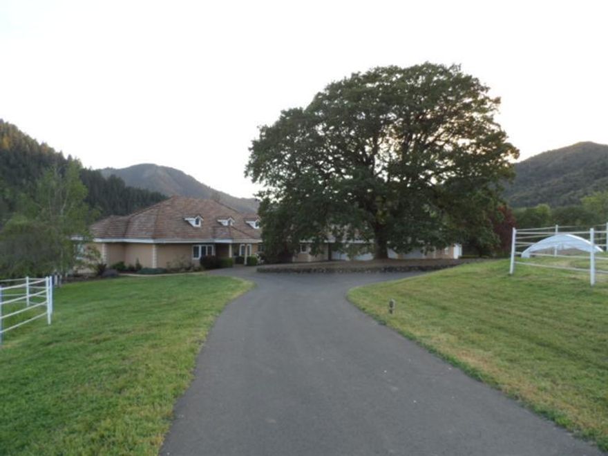 Country paradise awaits you. 38 acres, E Evans and May Creek frontage (Not in flood plain), irrigation, great views. Private, gated home w/paved drive, 3101 sf + 2 sunrooms for an add'l 370 sf all on one level. Huge 16x60 deck w/gazebo & gas fire pit, 3 bdrms, 2.5 baths, formal dining and living rms, family rm, split floor plan. Remodeled 2013-14: new DW, oven, MW & wine cooler. New water well pump & electrical. Paint inside & out. Two high efficiency heat pump systems new in 2013, 4 car garage (1 bay has workshop), RV garage + outside RV with all hookups. 12KW backup generator. 36x60 4-stall barn w/Nelson waterers, hay storage, tack & feed rms, wash bay w/hot water and vacuum, corral w/shelter, 3 pasture areas & an arena. Bottom land for hay production. Irrigation system complete w/20 HP pump, hand-lines and water cannons. Covered 36x48 equipment storage. Add in 4500' of new fencing and x-fencing. You will want to see this one. Broker owned.