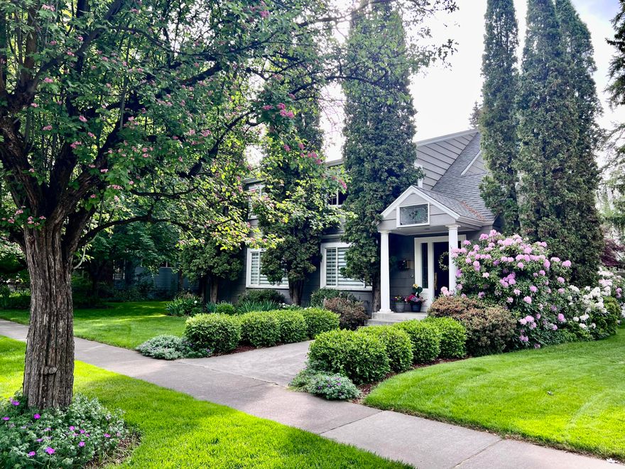 This inviting 5-bedroom, 3-bath home on a double lot in the historic district blends timeless elegance with modern convenience. It features original built-ins, spacious walk-in closets, and classic details that highlight its unique design. Located across from Drake Park, enjoy views of the lovely greens of summer, vivid colors of autumn, and snowy winter landscapes. Downtown dining, shopping and community events are a short stroll away. Inside, the spacious layout includes a formal living and dining room, eat-in kitchen with pantry, large game room, dedicated study, and an attic bedroom/bonus space. The master suite features vaulted ceilings, his & hers closets, and a generous en-suite bathroom. An unfinished  basement provides ample storage. Rhododendrons, hawthorn trees and a majestic European beech enhance the landscaping. A tandem 4-car garage and driveway with alley entrance ensures plentiful parking. Don't miss this opportunity to own a piece of history in a prime location!