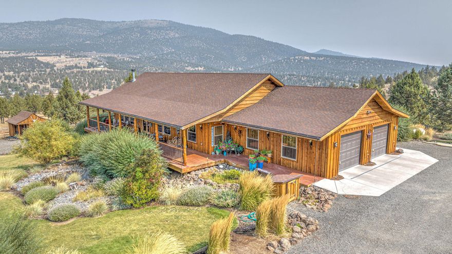 Enjoy privacy and gorgeous cascade mountain views in this immaculate custom home. The property is over 179 acres at the end of a long private drive that borders over 3000 acres of national grassland. The house has an open floor plan with a large kitchen featuring custom alder cabinets with pullout drawers, a large island and a beautiful copper farmhouse sink. The open living space is highlighted by a large rock fireplace with wood hearth. There are two master suites with large tiled walk in showers, walk in closets and a clawfoot tub and a good sized office that could easily be used as a third bedroom. Outside you will find a large workshop with plenty of extra storage and an attached studio apartment perfect for guests or extra income and full RV hookups. The yard is beautifully landscaped with automatic sprinklers and a large garden area. There are two loafing sheds for your animals with hay storage and a fully enclosed tack room. LOP tags are available.