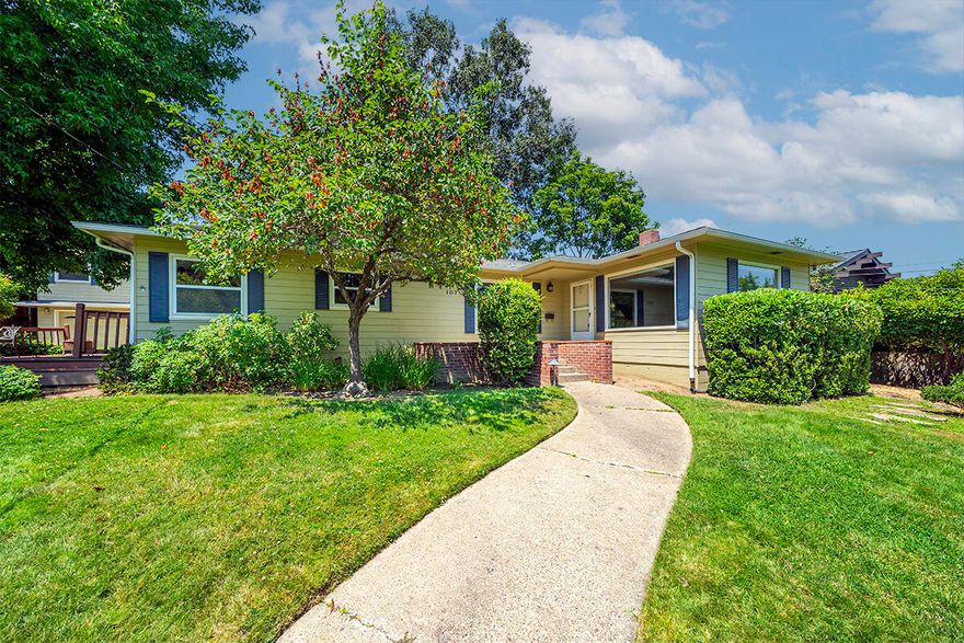 Midcentury ranch home with detached guest apartment on a large lot with mature trees located within 500 feet of Lithia Park - just two minutes from Ashland's downtown plaza! Main level living with large picture windows, custom built-in wood cabinets and window seat, fireplace with gas starter, formal dining and kitchen with solid oak hardwood floors, granite counters, butcher block dining bar, gas range with convection oven, breakfast nook, two bedrooms with closets, full bathroom with granite vanity and tub shower surround, office nook with built-ins, plus a bonus room studio or potential fourth bedroom with track lighting and sound insulation. Spacious upper-level primary suite with custom built-in wardrobes and window seat, integrated speakers, private balcony, and full ensuite bathroom with tiled vanity and tub shower surround. Detached two-car garage with renovated upper-level guest apartment complete with kitchenette, one bedroom, and full bath. Inquire for details!