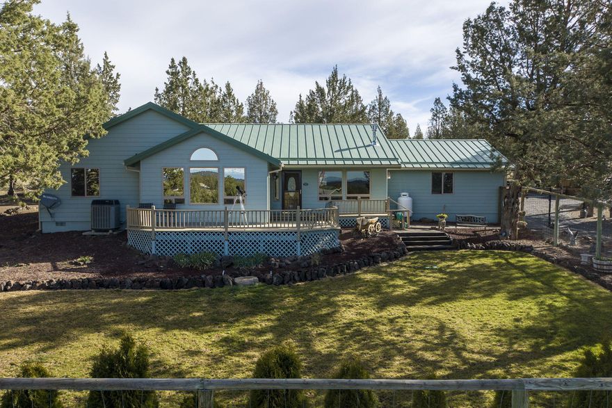 Well maintained and updated home w/must-see Cascade Mountain views on 5+ acres of exemplary outdoor space w/BLM access. The home features a metal roof, large front deck, heat pump, 200 amp power service and a soft water system. Numerous updates throughout home including quartz counters in the kitchen, bathrooms and office space. The kitchen showcases updated appliances and hardware and the bathrooms have new fixtures. The 20'x14' office space features 2 work areas. Outside are 3 RV spots w/water (1 has power) as well as a 200sqft. saloon-look shed w/porch. Newer 30'x45' metal pole barn shop w/concrete floor. Property has ample mature trees for privacy and yard is fenced w/a 7' horse fence. Beautifully set outdoor space has 12'x15' firepit w/4 custom benches and a 15'x15' concrete pad w/BBQ area and covered lodge pole table. There's also a 25'x35' garden area w/5 raised beds including a water system to each bed. Enjoy all the CRR amenities on this must-see to appreciate property!